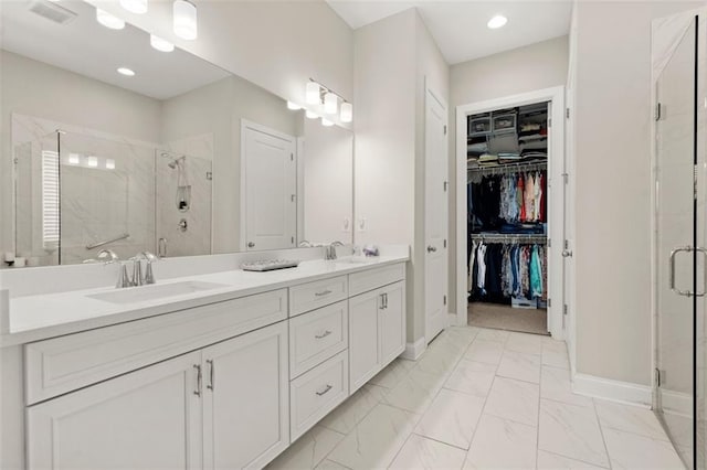 bathroom with a shower with door and vanity