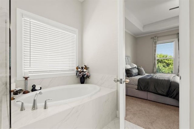 bathroom featuring crown molding and a relaxing tiled tub