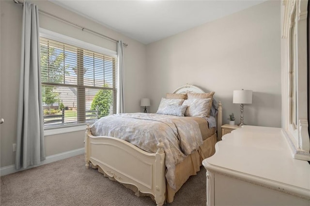 carpeted bedroom featuring multiple windows