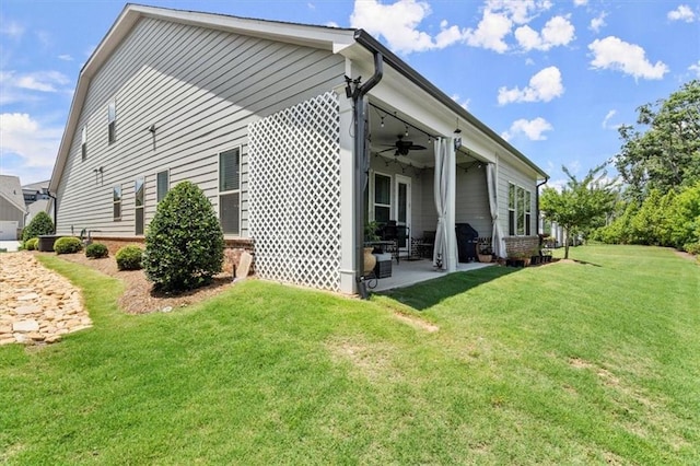 view of property exterior with a lawn, a patio area, and ceiling fan