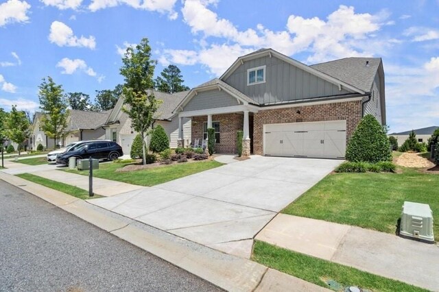 craftsman-style home featuring a front lawn and a garage