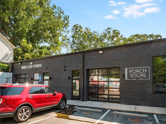 view of building exterior featuring uncovered parking