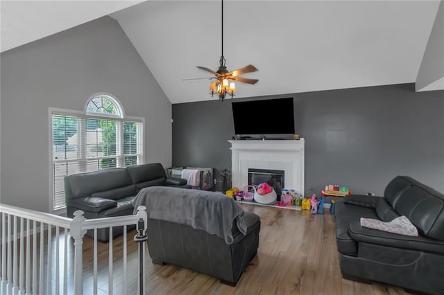 147 Midland Dr, Stockbridge, GA 30281 - living area featuring wood finished floors, ceiling fan, a glass covered fireplace, and high vaulted ceiling