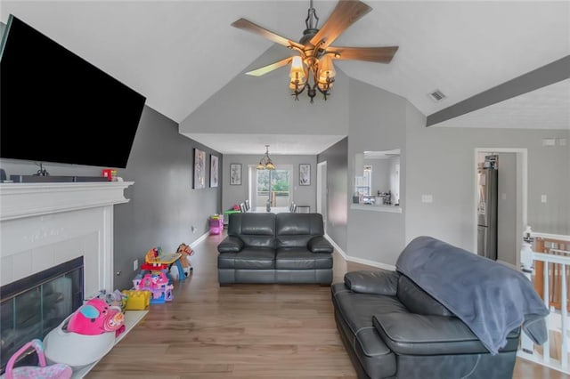 147 Midland Dr, Stockbridge, GA 30281 - living room featuring ceiling fan, baseboards, wood finished floors, a fireplace, and high vaulted ceiling