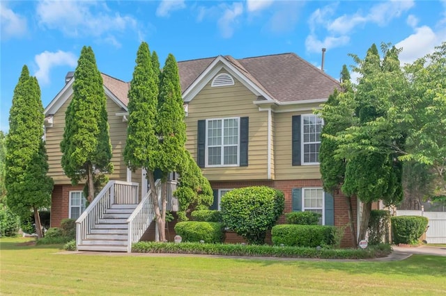 147 Midland Dr, Stockbridge, GA 30281 - view of front facade featuring brick siding, a front yard, and roof with shingles