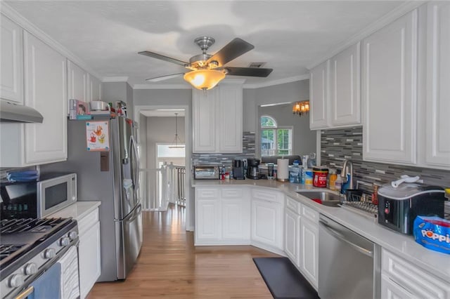 147 Midland Dr, Stockbridge, GA 30281 - kitchen featuring stainless steel appliances, a sink, light countertops, decorative backsplash, and ornamental molding