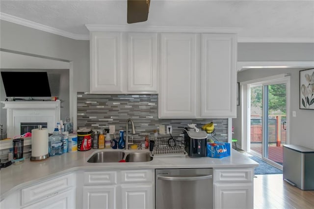 147 Midland Dr, Stockbridge, GA 30281 - kitchen featuring dishwasher, a sink, backsplash, white cabinets, and light countertops