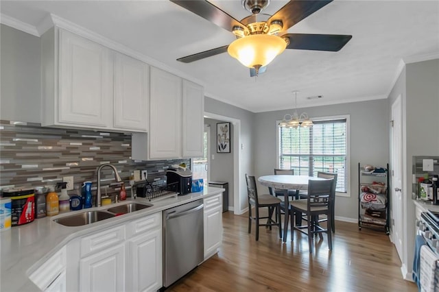 147 Midland Dr, Stockbridge, GA 30281 - kitchen featuring appliances with stainless steel finishes, a sink, backsplash, white cabinets, and wood finished floors