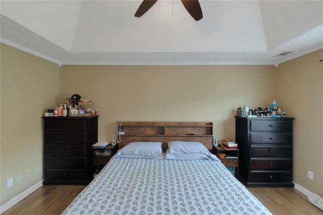 147 Midland Dr, Stockbridge, GA 30281 - bedroom with wood finished floors, vaulted ceiling, a raised ceiling, baseboards, and ornamental molding
