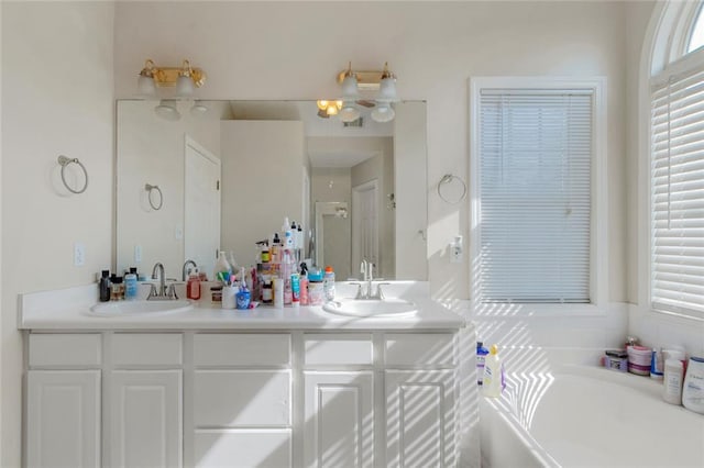147 Midland Dr, Stockbridge, GA 30281 - bathroom with double vanity, a garden tub, and a stall shower
