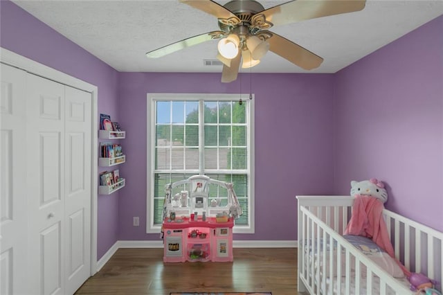 147 Midland Dr, Stockbridge, GA 30281 - bedroom with wood finished floors, a closet, baseboards, ceiling fan, and a crib