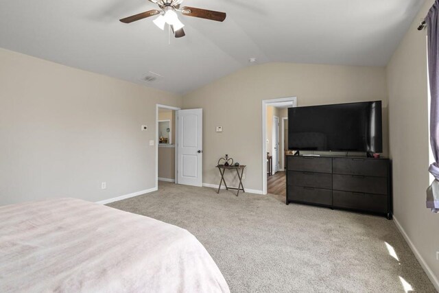 bedroom featuring light colored carpet, a ceiling fan, baseboards, and vaulted ceiling