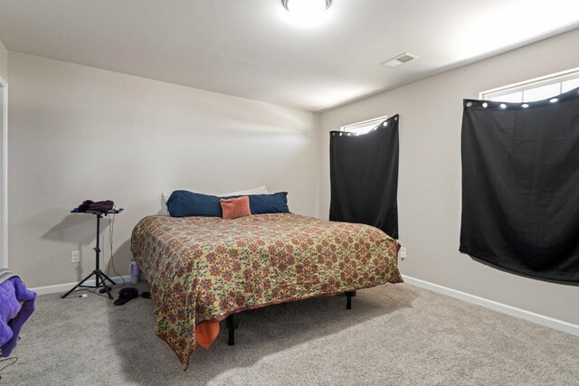 carpeted bedroom with baseboards and visible vents