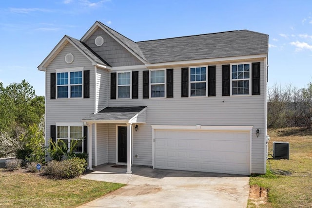 view of front of property with cooling unit, an attached garage, and concrete driveway