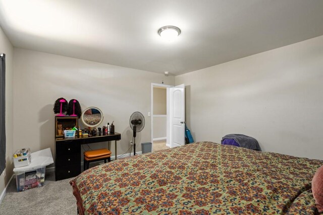 bedroom with carpet flooring and baseboards