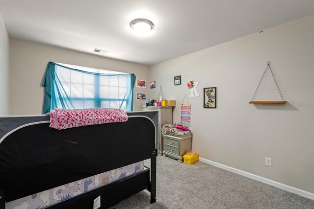 carpeted bedroom with visible vents and baseboards