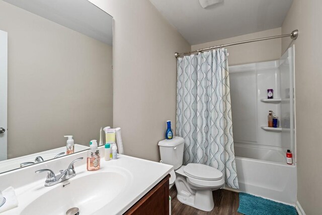 full bath with vanity, shower / bath combination with curtain, toilet, and wood finished floors