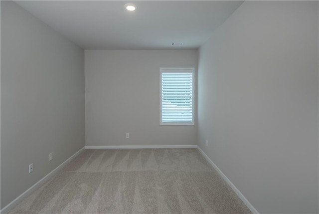 unfurnished room with light colored carpet