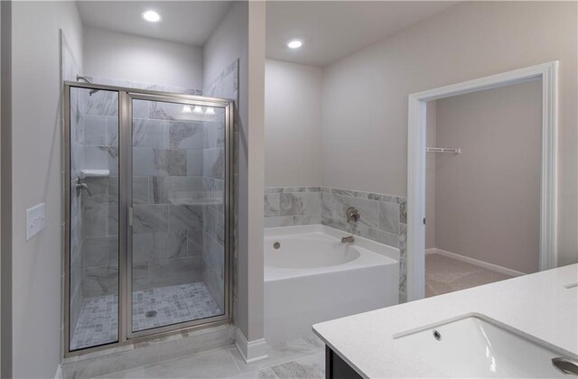 bathroom featuring shower with separate bathtub and vanity