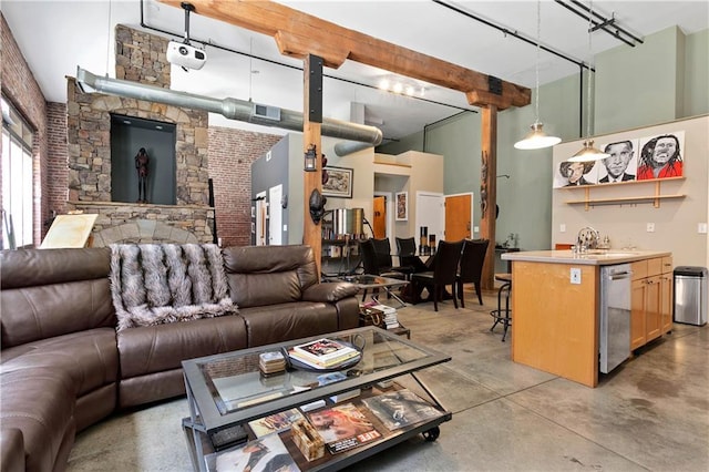 living room featuring visible vents, beamed ceiling, finished concrete floors, a high ceiling, and wet bar