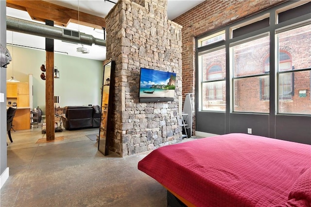 bedroom featuring a towering ceiling, visible vents, and concrete flooring