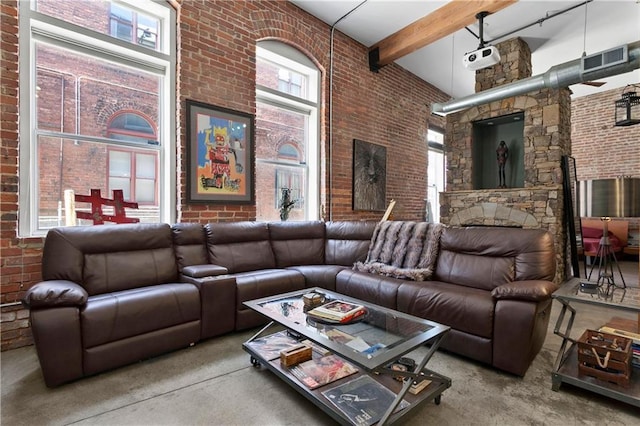 living room featuring brick wall, beam ceiling, and a towering ceiling