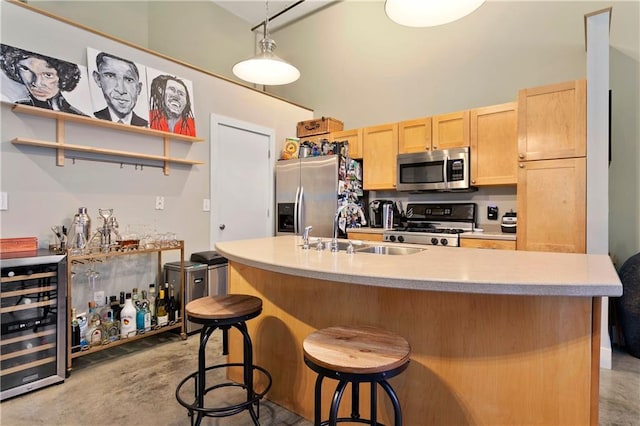 kitchen with wine cooler, light brown cabinets, stainless steel appliances, concrete floors, and a sink