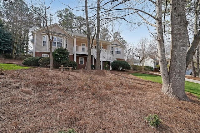 view of front facade with brick siding and covered porch