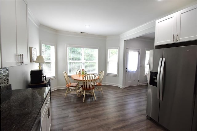 dining space featuring crown molding and dark hardwood / wood-style floors