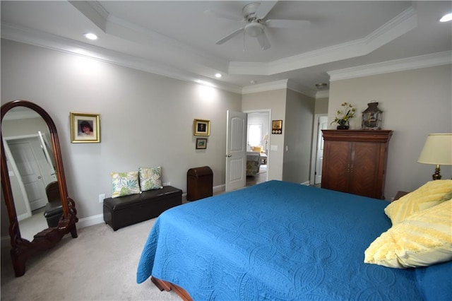 bedroom with a raised ceiling, ceiling fan, light carpet, and ornamental molding