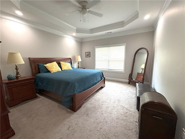 carpeted bedroom with a raised ceiling, ceiling fan, and crown molding