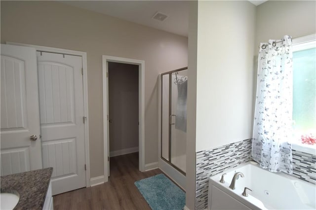 bathroom with vanity, wood-type flooring, and shower with separate bathtub