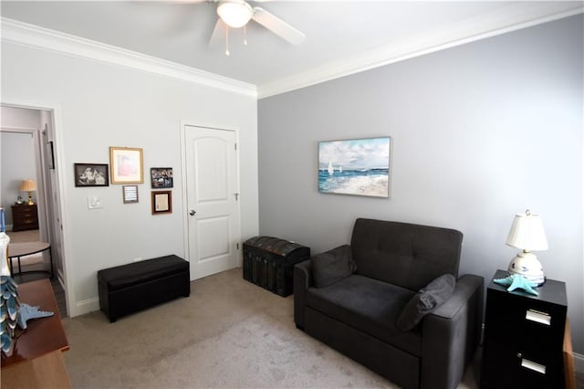 carpeted living room with ceiling fan and ornamental molding