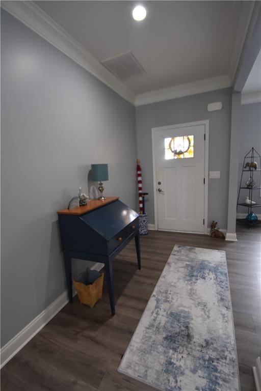 foyer entrance with crown molding and dark hardwood / wood-style flooring