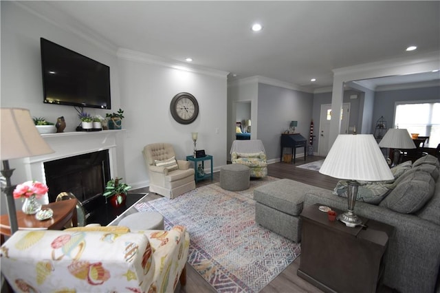 living room with wood-type flooring and ornamental molding