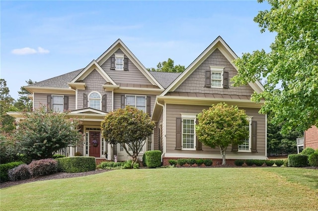 craftsman-style home with a front yard