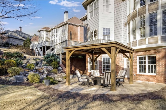 rear view of property with a gazebo and a patio