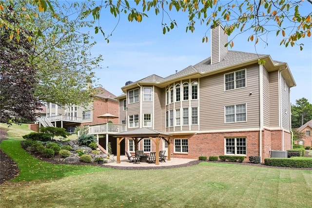 rear view of house with a gazebo, a yard, and a patio