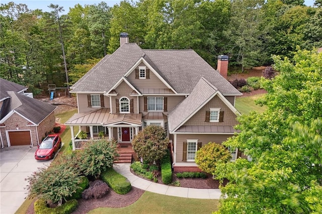 craftsman house featuring covered porch and a garage