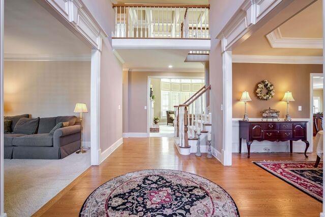 entrance foyer with light wood-type flooring and ornamental molding