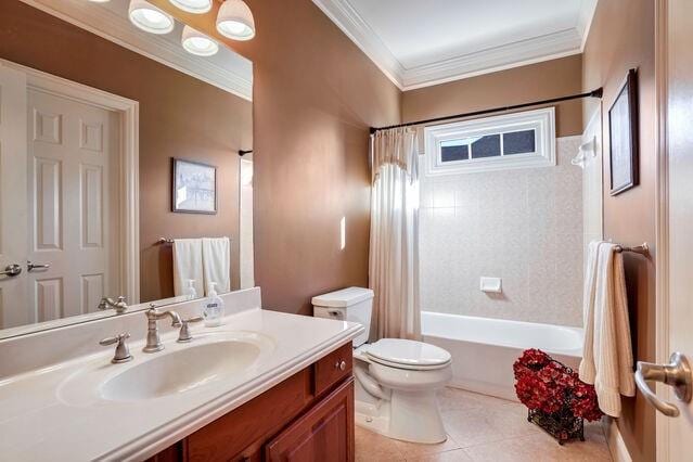 full bathroom with tile patterned flooring, toilet, shower / tub combo with curtain, vanity, and ornamental molding