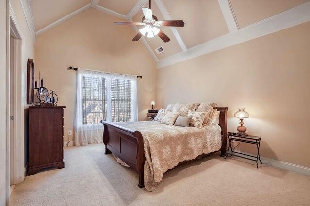 bedroom with ceiling fan, light carpet, and high vaulted ceiling