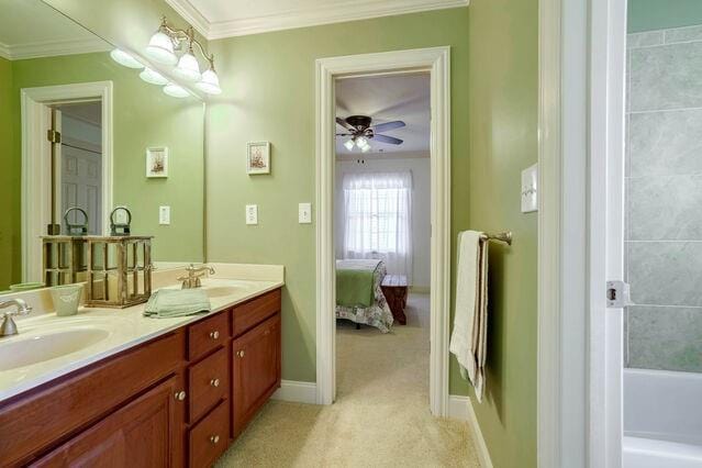 bathroom with vanity, ceiling fan, and crown molding