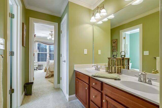 bathroom with vanity, ceiling fan, and ornamental molding