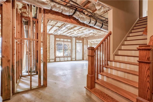 stairs with concrete flooring