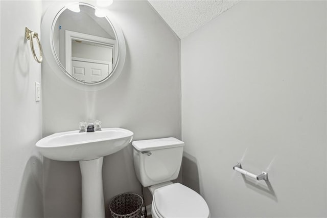 bathroom featuring a textured ceiling and toilet