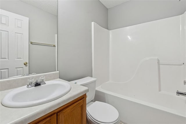 full bathroom featuring vanity, toilet, shower / bath combination, and a textured ceiling