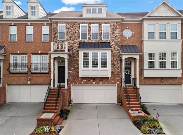 multi unit property with brick siding, concrete driveway, and a garage