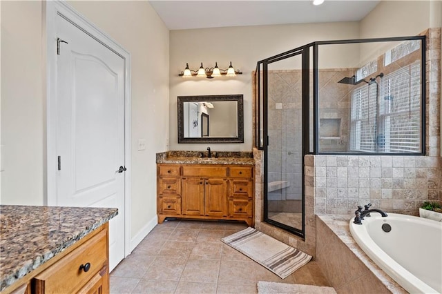 5955 Manchester Ln, Gainesville, GA 30506 - full bath featuring vanity, a stall shower, a garden tub, tile patterned floors, and baseboards