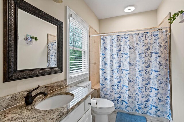 5955 Manchester Ln, Gainesville, GA 30506 - bathroom with vanity, toilet, tile patterned flooring, and shower / bath combo with shower curtain